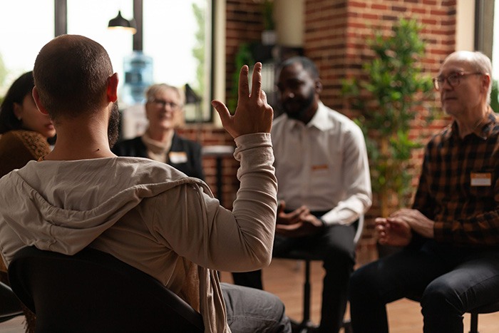 People participate in therapy at a drug rehab center.