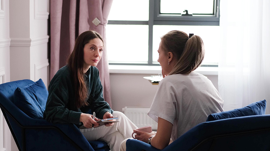 A woman participates in therapy at a drug rehab.